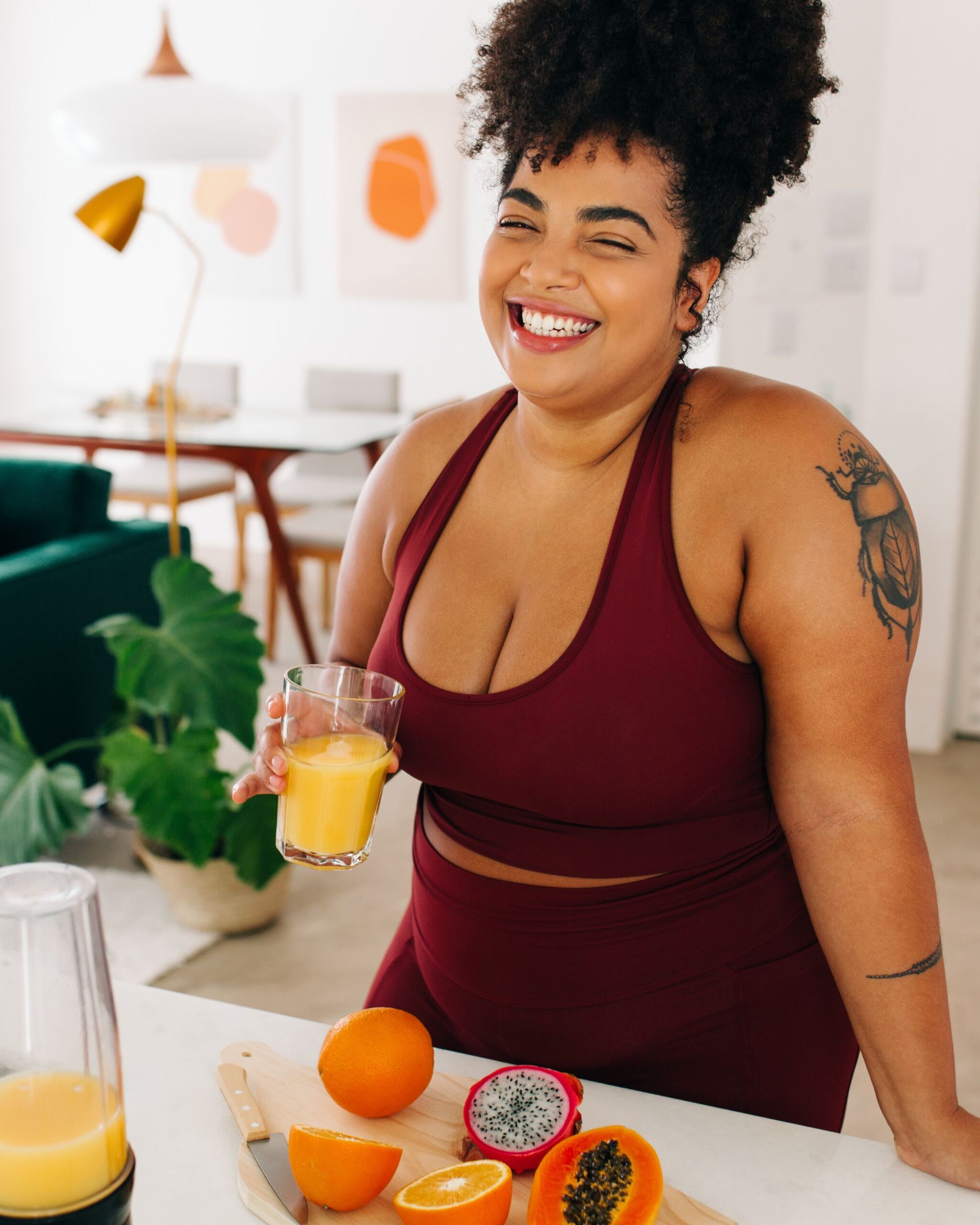 woman standing at the kitchen counter with a glass of orange juice